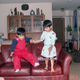 Best friends jumping on our grandparents’ couch in 1989.